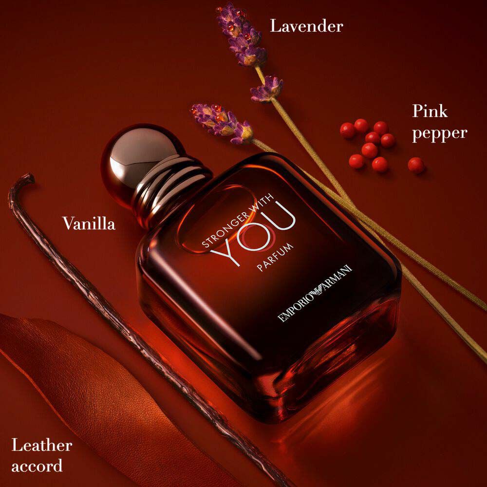 Emporio Armani Stronger With You Parfum — 100ml deep red bottle surrounded by key olfactive ingredients: lavender, pink pepper, vanilla, and leather accord on a rich amber background.