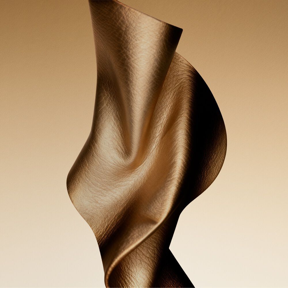 Golden fabric texture evoking the leather accord of Cuir Dore.