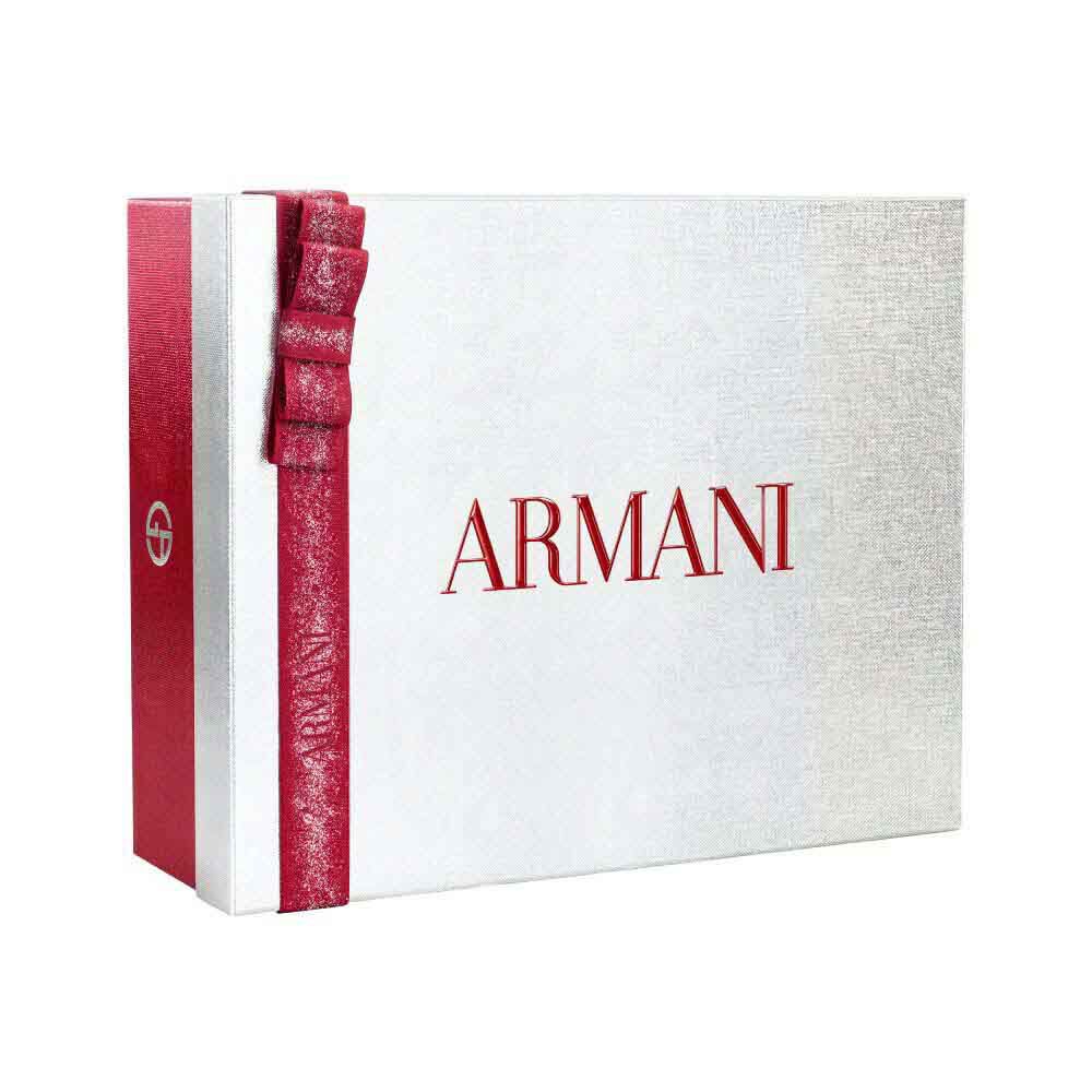 Silver Armani holiday gift box with glittered red ribbon bow — Glamourous Winter Holiday Gift Set Box, white background.