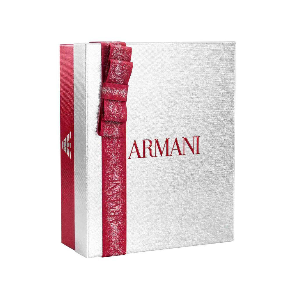 Silver Armani holiday gift box with glittered ruby ribbon bow — Glamourous Winter Holiday Gift Set Box, white background.