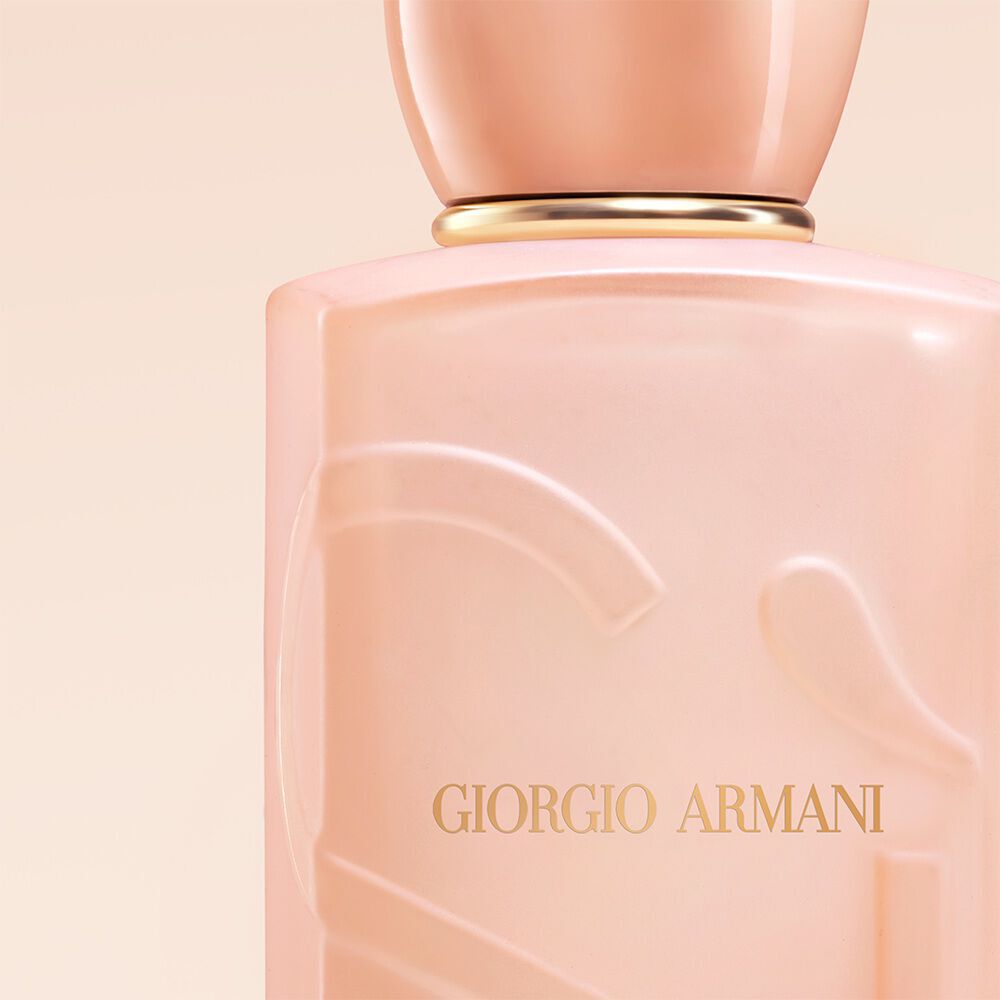 Giorgio Armani Si Nude Bloom perfume close up on the bottle on a nude background.