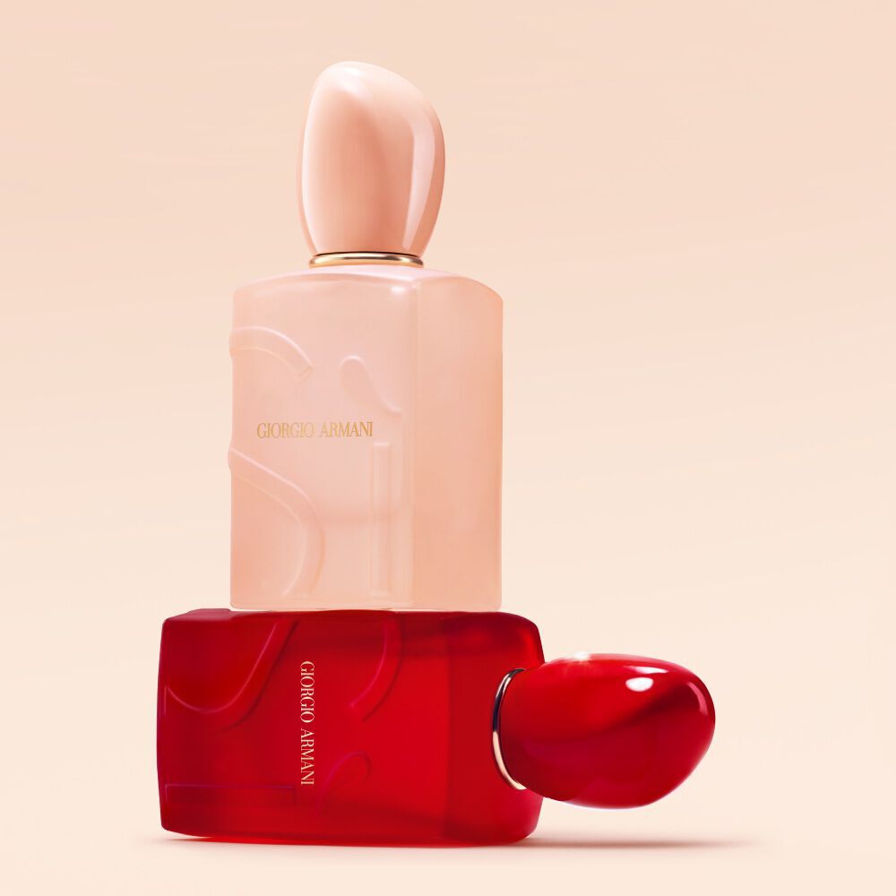 Giorgio Armani Si Nude Bloom and Si Passione Red Bloom bottles stacked on a nude background.