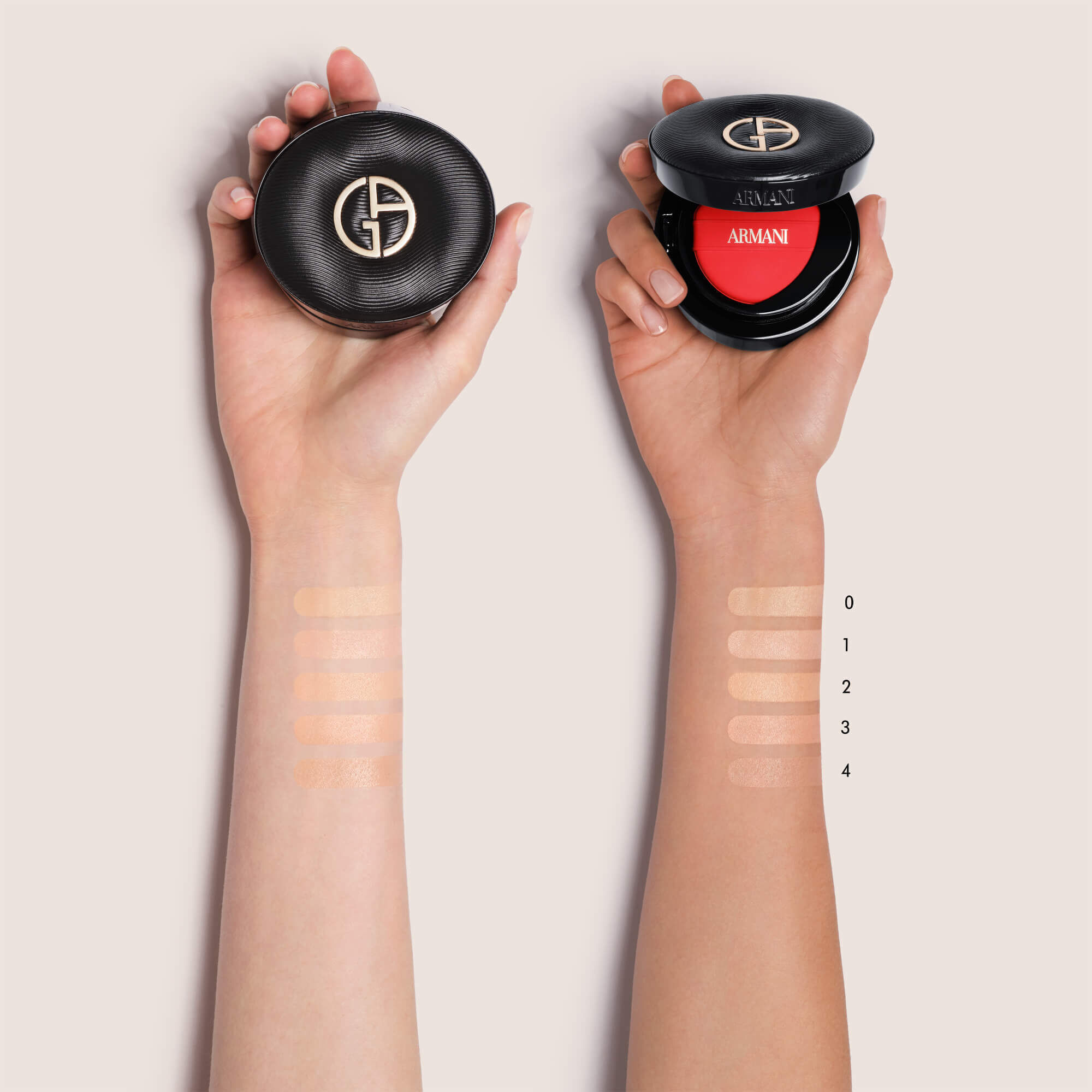 Two hands holding Giorgio Armani LUMINOUS SILK PRIMA GLOW CUSHION compacts, with foundation swatches labeled 0 through 4 on the forearms to display different shades