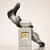 Armani Prive Oud Nacre perfume bottle with flowing Oud in the back